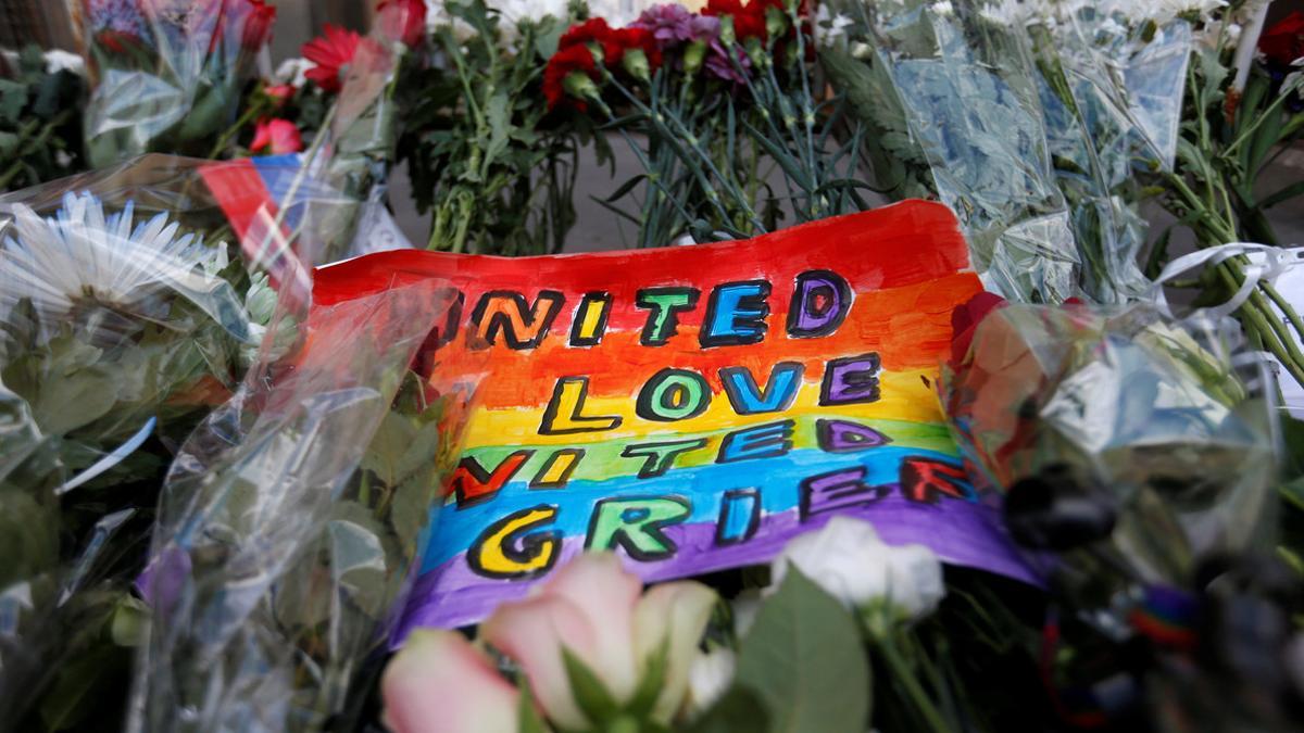 A placard and flowers for the victims of the shooting at a gay nightclub in Orlando are seen in front of the U.S. Embassy in Moscow