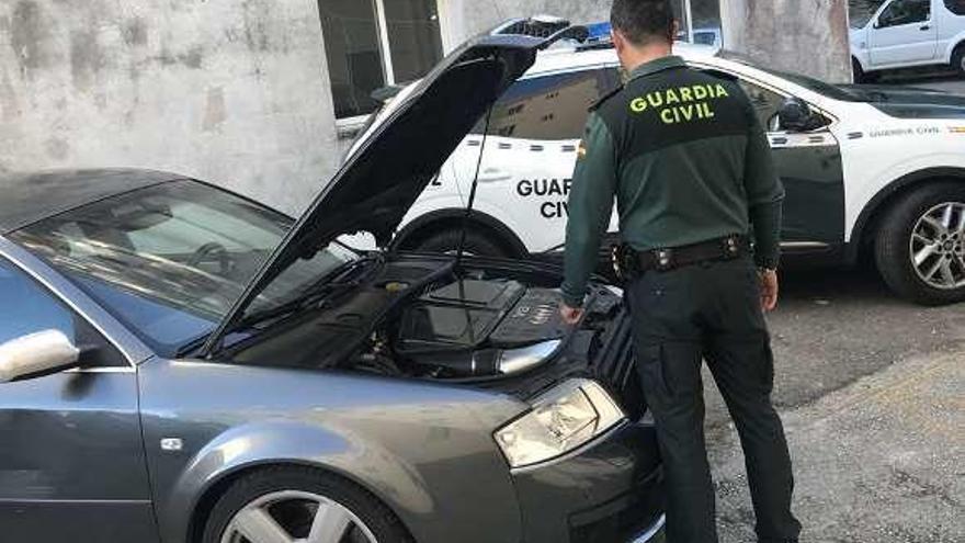 Un agente inspecciona uno de los vehículos trucados.