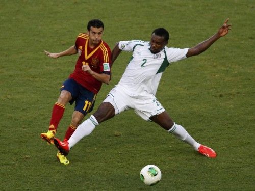 Spain's Pedro fights for the ball with Nigeria's Godfrey Oboabona during their Confederations Cup Group B soccer match at the Estadio Castelao in Fortaleza