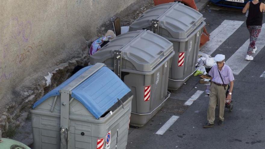Los peatones se bajan a la calzada en José Reus García, con una acera de 30 centímetros y el paso cortado por basura junto a los contenedores.