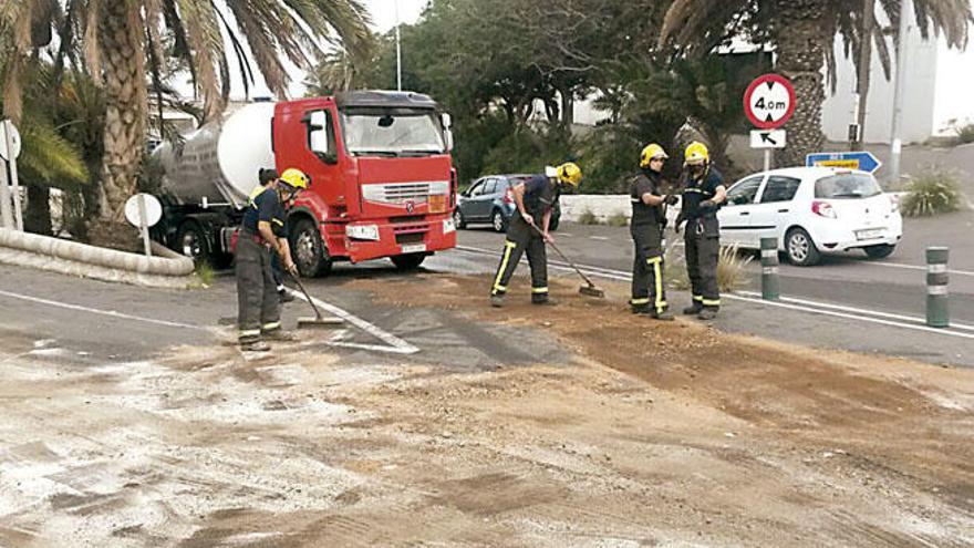 Los bomberos, junto al camión que perdió combustible en Telde.
