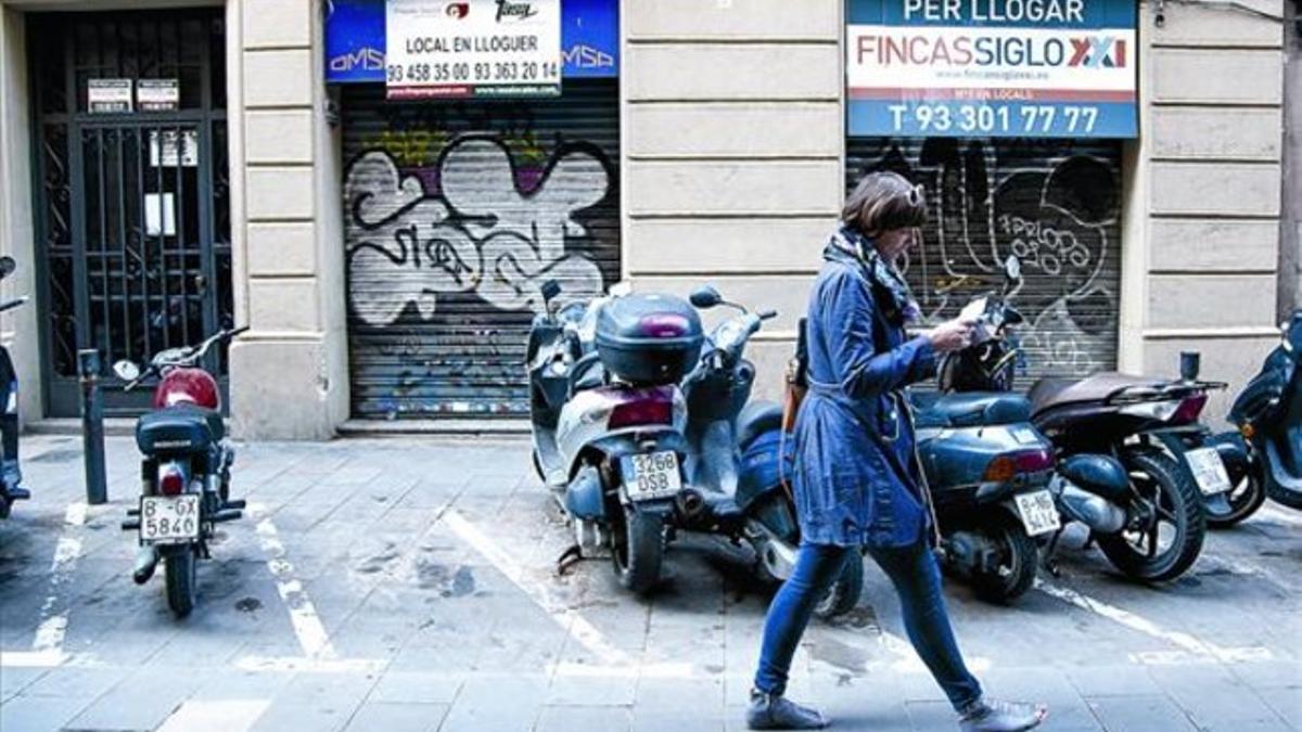 Locales comerciales cerrados en la calle de Sant Pere més Alt, en Ciutat Vella.