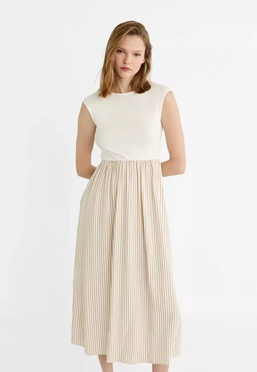 Lucirás impecable con estos 7 vestidos midi de Stradivarius: perfectos para ir a la oficina 6 Moncloa Vestido midi combinado de Stradivarius: sofisticación y versatilidad