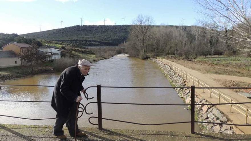 Un vecino pasa por el puente sobre el Eria en Villaferrueña.