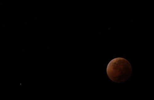 The moon is seen as it begins a total lunar eclipse over Buenos Aires