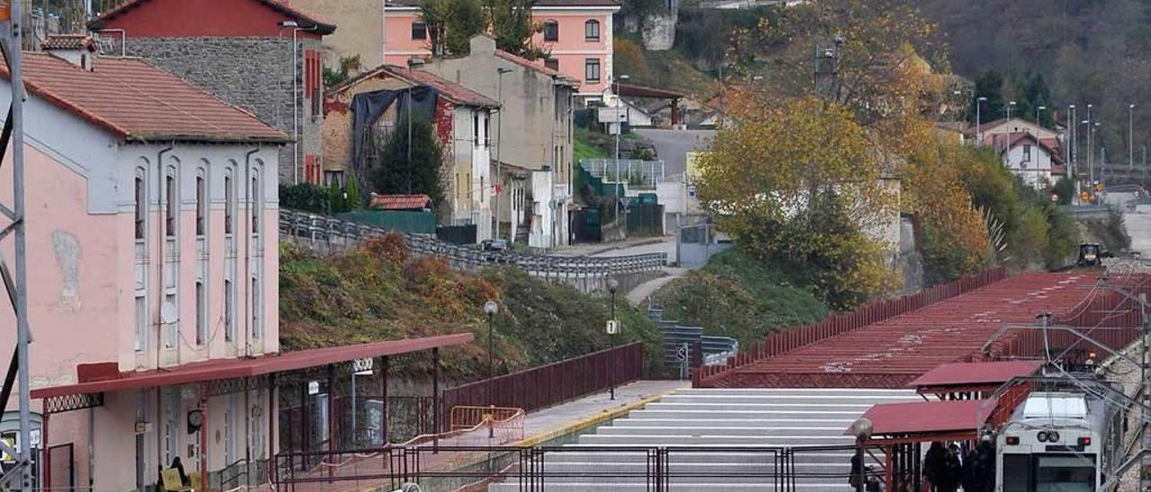 Obras de soterramiento en La Felguera, con un tren a la derecha.