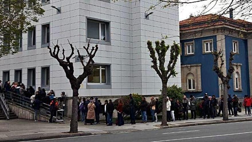 Decenas de personas esperan a las puertas de la oficina de extranjería, ayer a primera hora de la mañana.