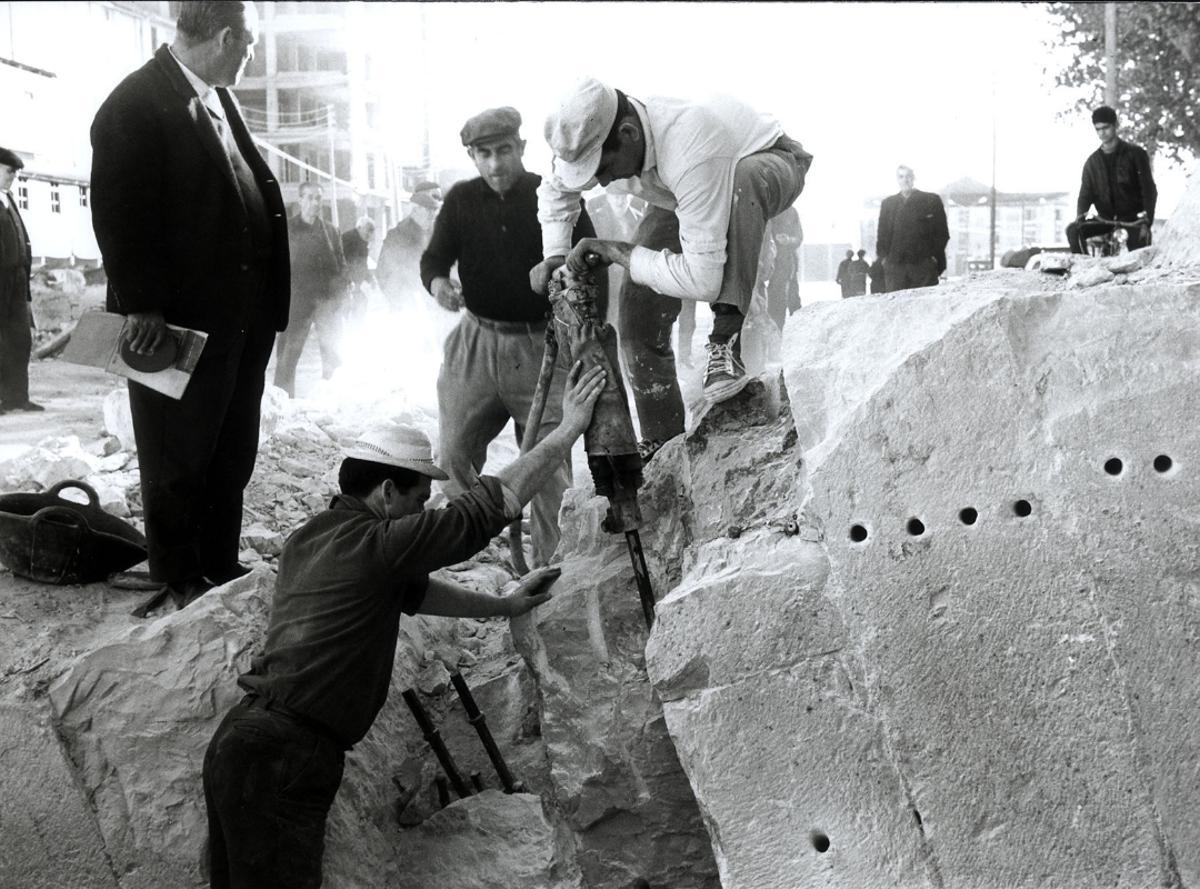 Alzira 1966. El desarrollismo de los años sesenta transformó el perfil de muchas ciudades. Alzira apostó por derribar el histórico Pont de Sant Bernat, cuyos orígenes se remontan al siglo XIII, para levantar una pujante avenida llena de grandes edificios. Del puente solo quedan en pie los casilicios y una parte del pretil reconstruido recientemente.