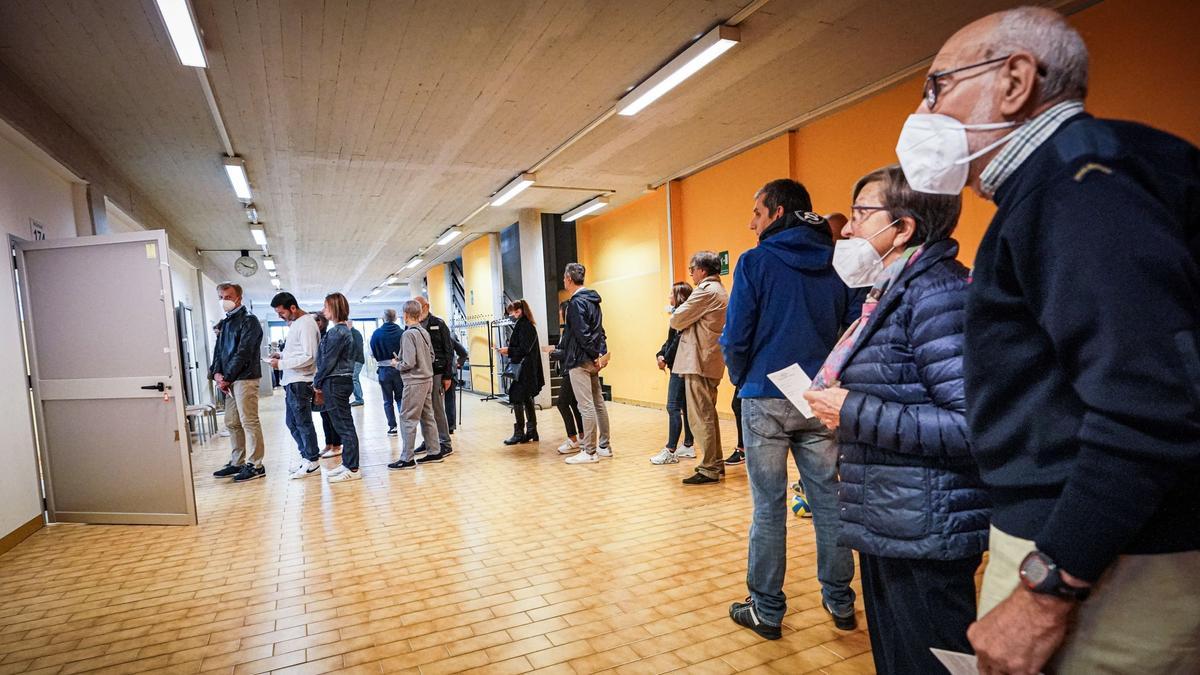 La gente asiste a la votación en las elecciones generales italianas en un colegio electoral en Turín, Italia.