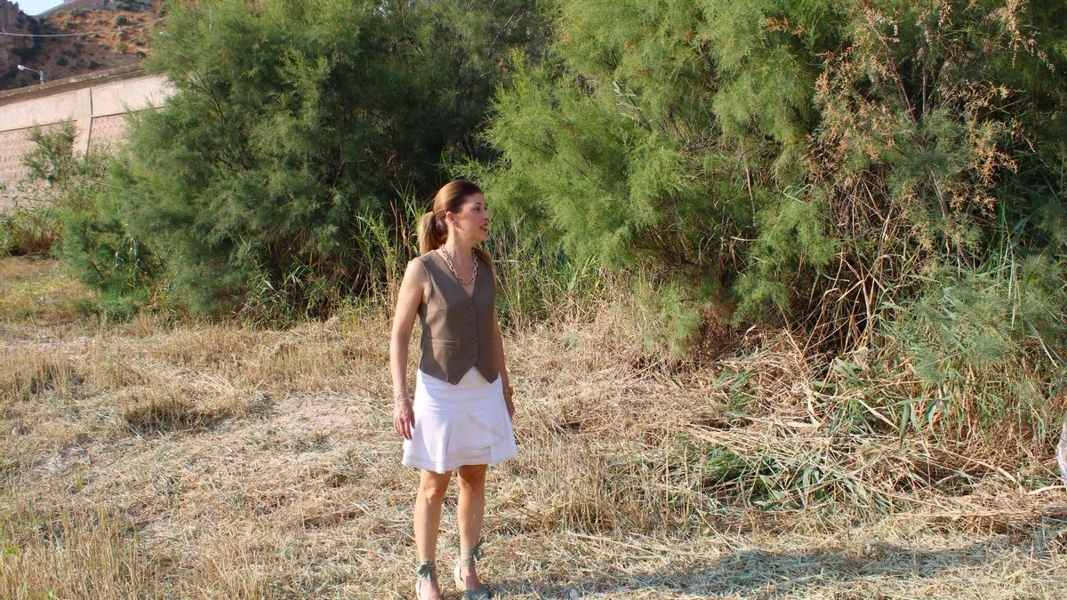 Rosa Medina, edil de Desarrollo Local, contempla un fragmento del río ya desbrozado.