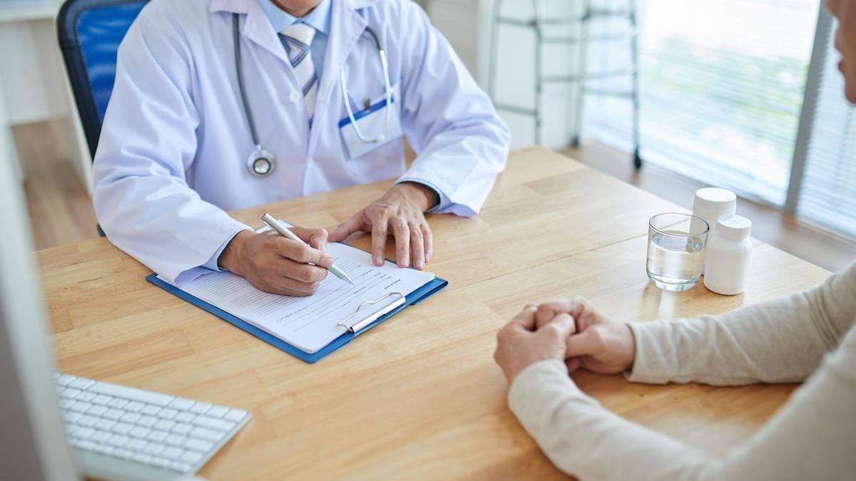 Una mujer consulta con su médico.