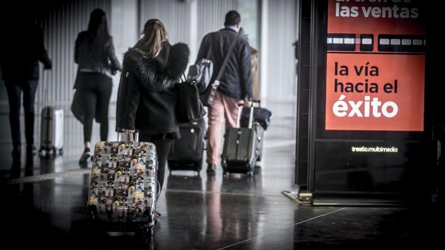 Varios viajeros se dirigen a tomar el tren en la estación de Alicante.