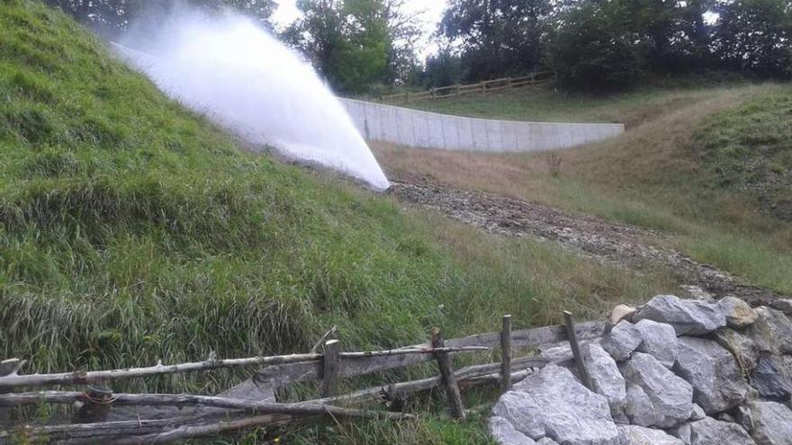 Agua saliendo a presión de la tubería después del reventón a la altura de Soto de Caso.