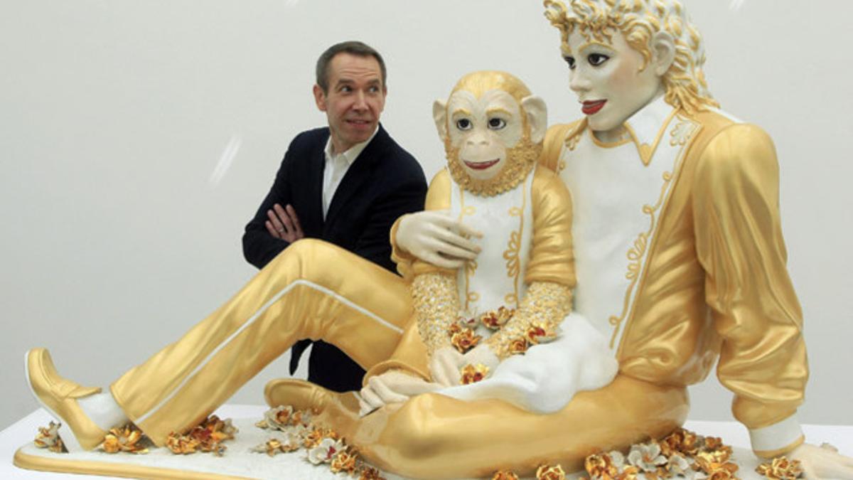 U.S.artist Koons poses beside his sculpture 'Michael Jackson and Bubbles' during a media preview of his exhibition at the Fondation Beyeler in Riehen