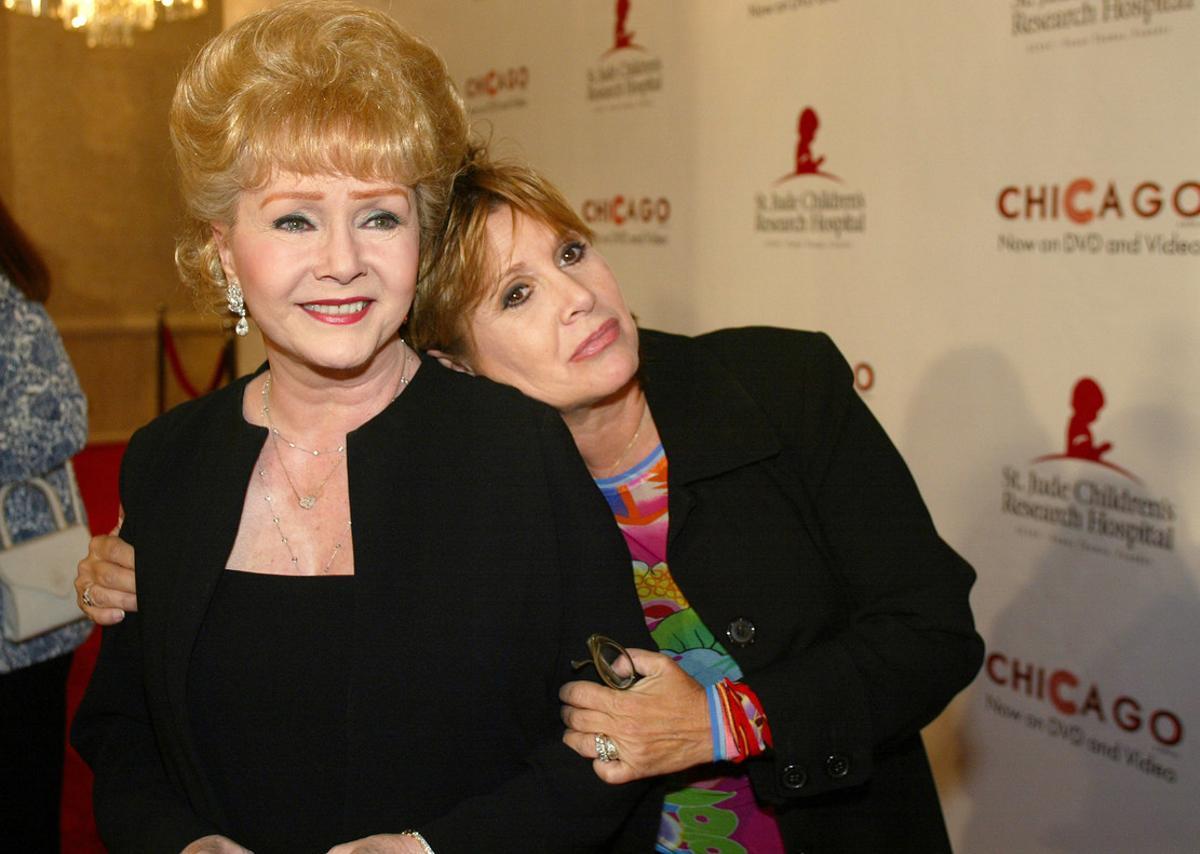 FILE - In this Tuesday, Aug. 19, 2003 file photo, Debbie Reynolds and Carrie Fisher arrive at the Runway for Life Celebrity Fashion Show Benefitting St. Jude’s Children’s Research Hospital and celebrating the DVD relese of Chicago in Beverly Hills, Calif. On Tuesday, Dec. 27, 2016, a publicist said Fisher has died at the age of 60. (AP Photo/Jill Connelly, File)