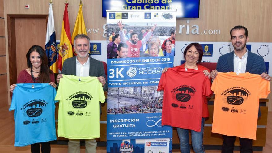 Representantes organizativos del Gran Canaria Maratón posan con las camiseta del evento accesible