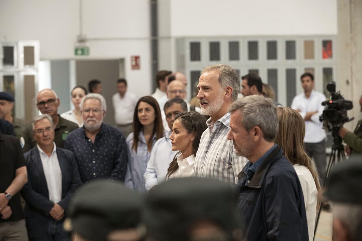 Los reyes Felipe VI y Letizia conversan con un grupo de representantes de los medios de extinción de incendios que han participado en las labores en la zona mientras visitan el Centro de Coordinación del Distrito Forestal XIV de Verín (Ourense)