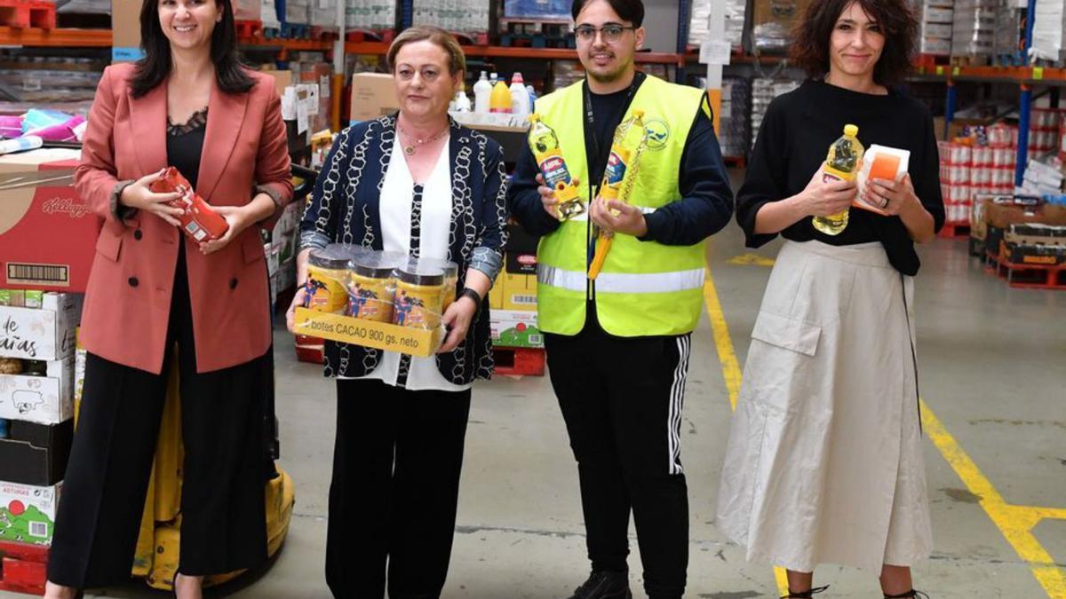 De izqda. a dcha., Marta Albela, directora comercial de CaixaBank en Galicia; Conchi Rey, en representación de los bancos de alimentos; un voluntario y Susan Santos, delegada de la Fundación ”la Caixa” en Galicia, ayer, en A Coruña.  | // VÍCTOR ECHAVE