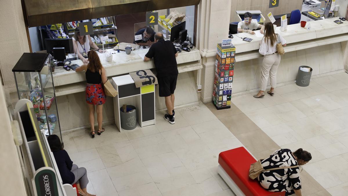 Varias personas, en la oficina de Correos en Zaragoza, solicitando el voto por Correo.