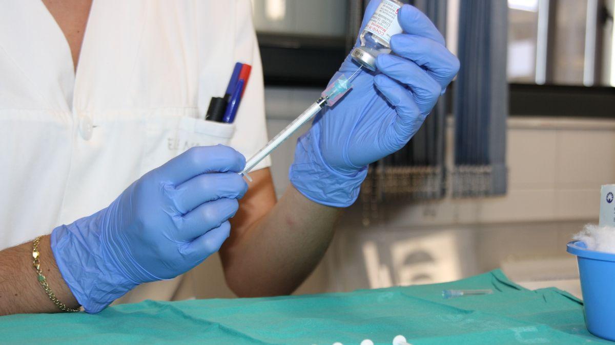 Un sanitario preparando una vacuna contra la covid. / EP