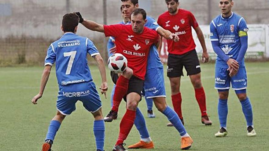 El benaventano Javi disputa el balón a Nacho y Marco, del Villaralbo.