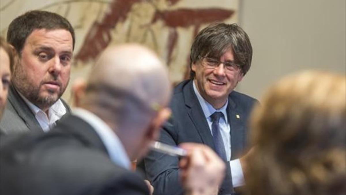 El 'president' Carles Puigdemont y el vicepresidente Oriol Junqueras, en la primera reunión del Govern de la Generalitat constituido ayer.