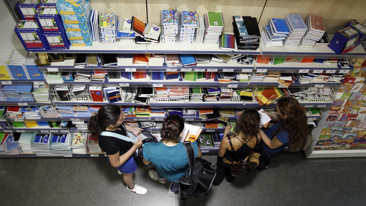 Padres y niños buscan material escolar para la vuelta al colegio en una tienda Abacus.