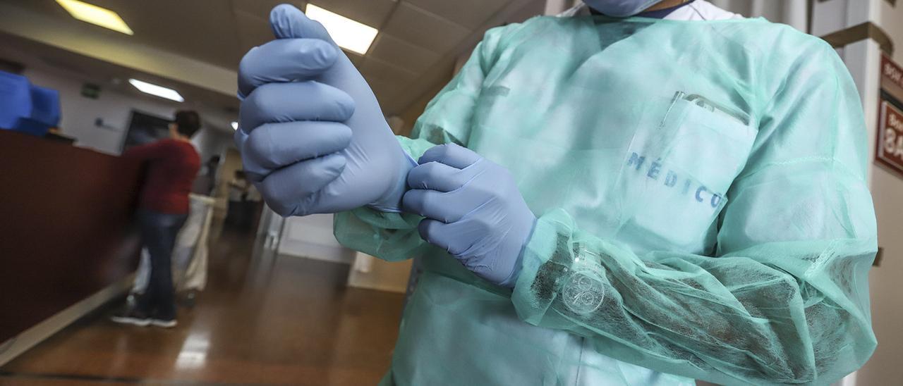 Un médico se pone unos guantes en una foto de archivo.