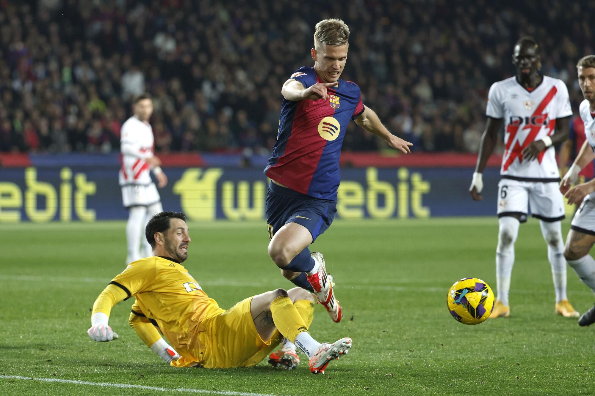 Barcelona's Dani Olmo, centre, in action during a Spanish La Liga soccer match between Barcelona and Rayo Vallecano at the Lluis Companys Olympic Stadium in Barcelona, Spain, Monday, Feb. 17, 2025. (AP Photo/Joan Monfort)