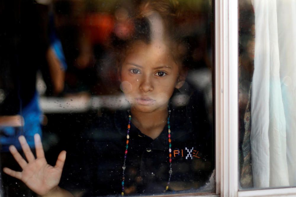 A Central American migrant, moving in a caravan ...