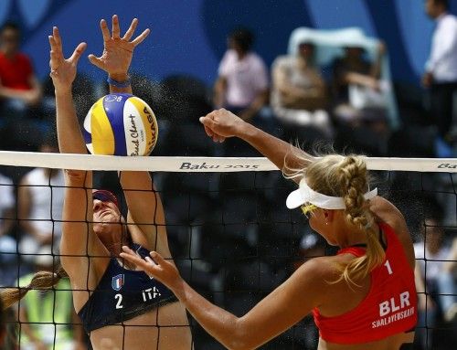 Gioria of Italy blocks a shot of Siakretava of Belarus during their preliminary beachvolleyball match at the 1st European Games in Baku