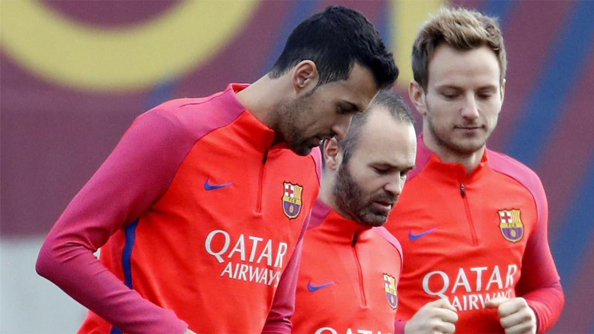 Sergio Busquets, Andrés Iniesta e Ivan Rakitic durante un entrenamiento del FC Barcelona