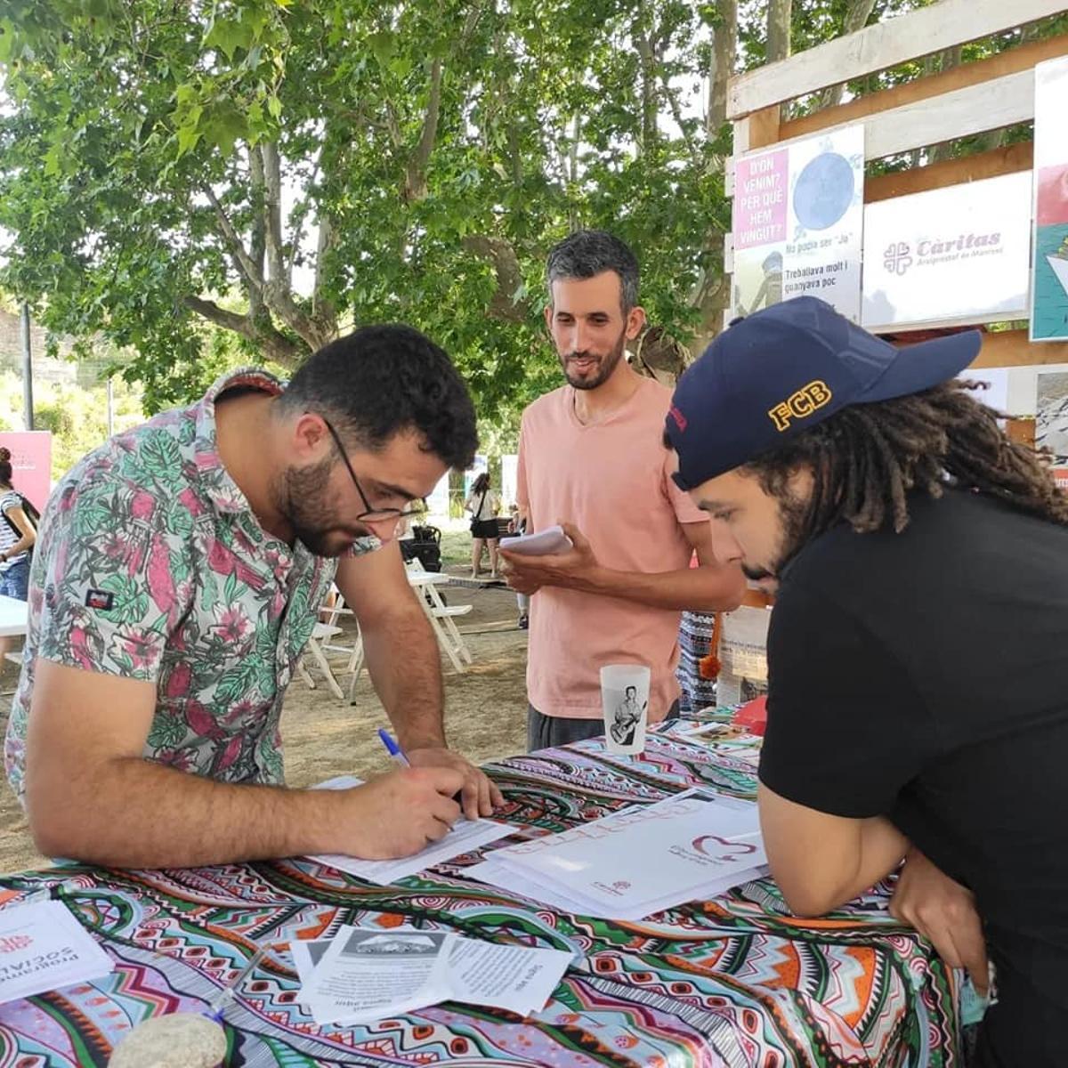 Recollida de signatures a favor de la mesura que va organitzar Càritas Manresa l'any 2022 a la festa del Riu