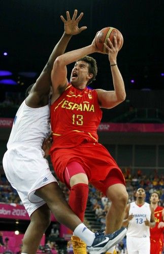 Spain's Gasol is guarded by France's Seraphin during their men's quarterfinal basketball match at the North Greenwich Arena in London during the London 2012 Olympic Games