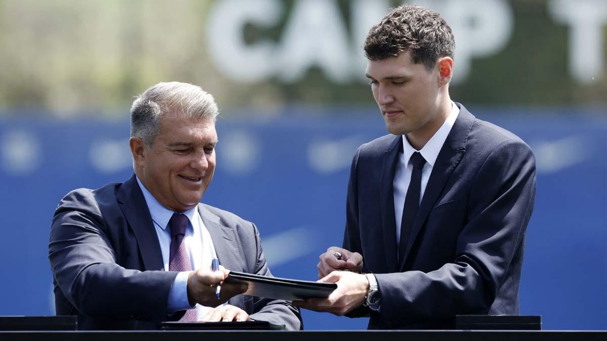  El presidente del FC Barcelona, ​​Joan Laporta, y el nuevo jugador Andreas Christensen firman contratos durante la presentación.