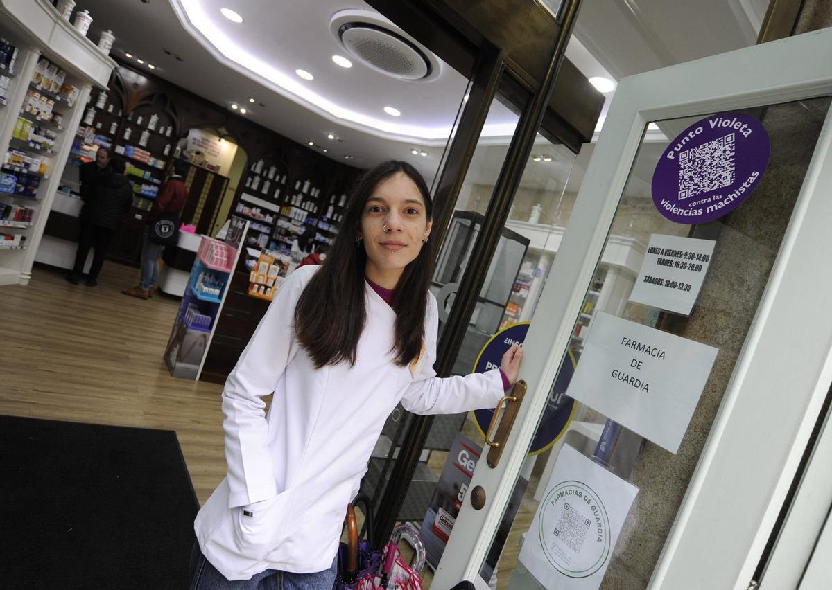Una trabajadora de la Farmacia Madriñán Batán, en Lalín, ante la señal del punto violeta. | BERNABÉ/JAVIER LALÍN