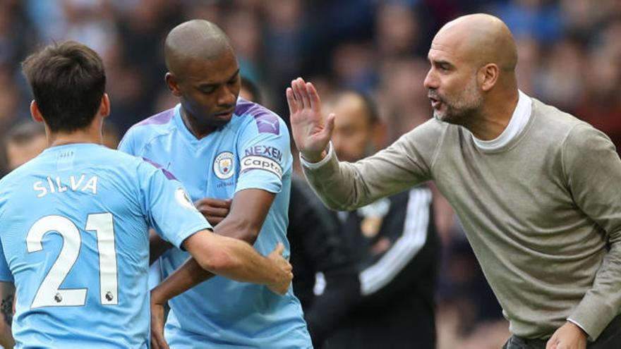 Guardiola y David —este de espaladas— durante un encuentro.