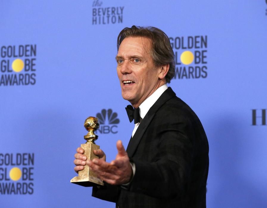 Hugh Laurie holds his award during the 74th ...
