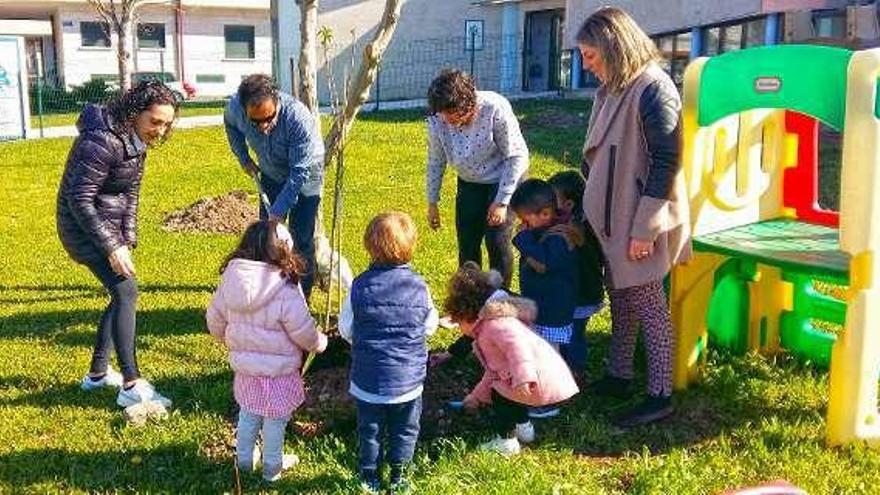 Piñeiro y algunos de los niños, en la plantación de árboles. // FdV