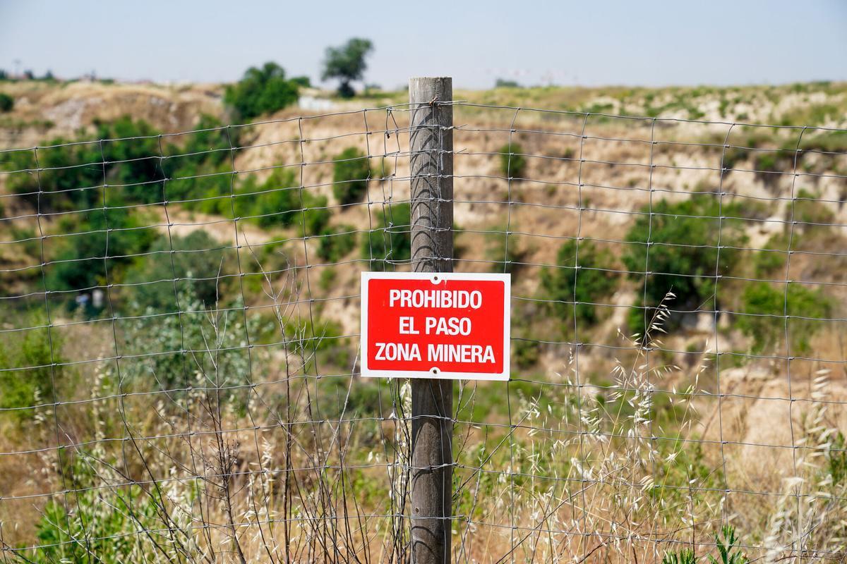 09/06/2021 Un cartel de prohibido el paso en la zona perteneciente a la explotación minera de Tolsadeco donde ayer se ahogó un menor, a 9 de junio de 2021, en Madrid, (España). La compañía minera Tolsa, explotadora del yacimiento de las Lagunas de Ambroz, ha lamentado el ahogamiento del menor de edad después de recordar que en la zona está prohibido el baño. El menor extranjero no acompañado que murió este martes ahogado cuando se bañaba con un grupo de amigos en las Lagunas de Ambroz, ubicadas en el distrito madrileño de San Blas-Canillejas, no sabía nadar, según han indicado a Europa Press fuentes de la investigación. Tolsa recuerda que esta zona está perimetralmente vallada y señalizada, con carteles que advierten que se trata de una zona minera peligrosa y de prohibido acceso. POLITICA A. Pérez Meca - Europa Press