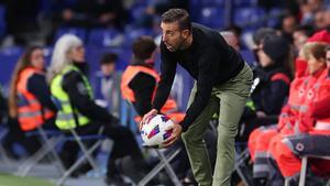 Luis García recoge un balón durante el choque ante el Eibar en Cornellà, su último partido como técnico del Espanyol.