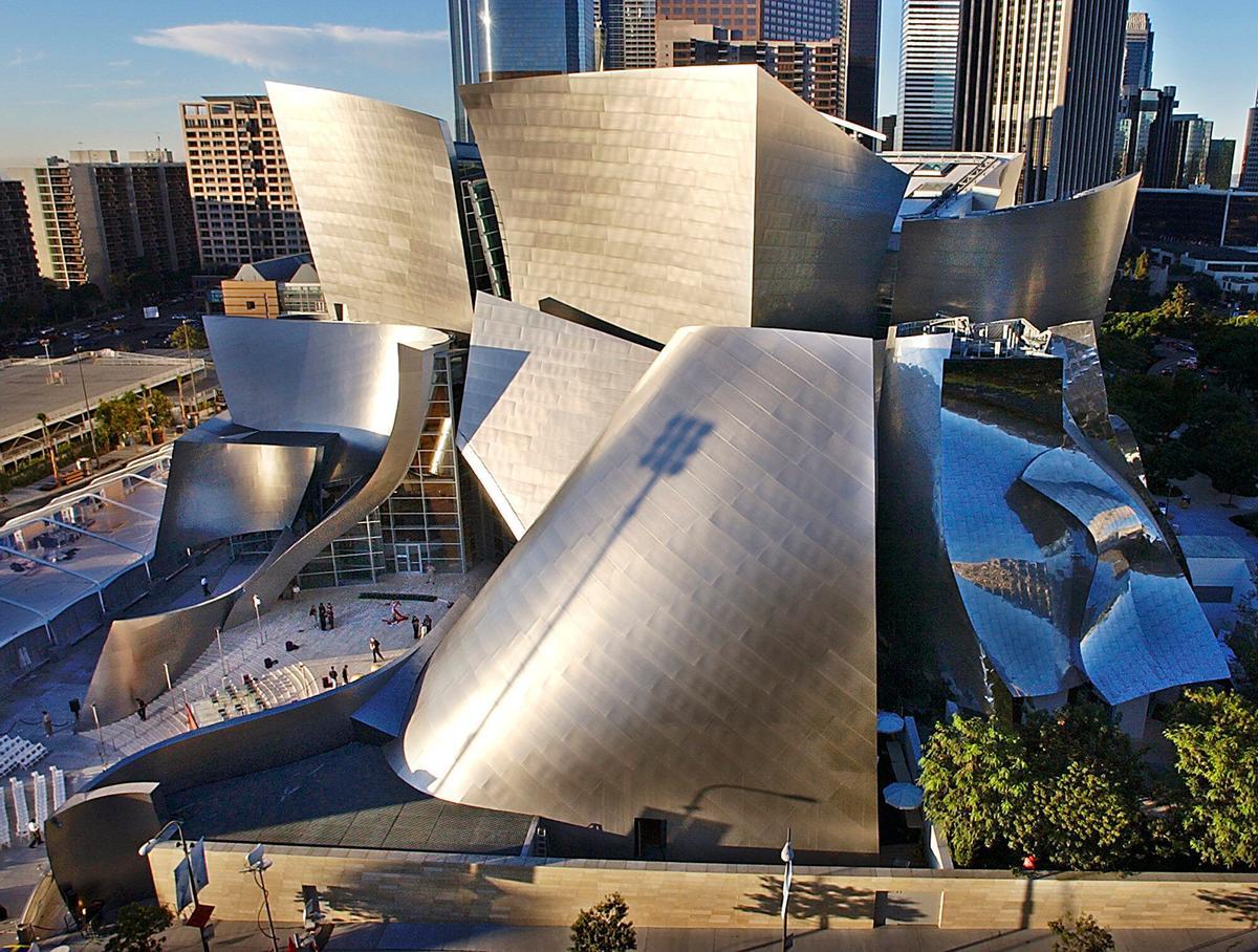 FILE - This Oct. 20, 2003 file photo shows early morning sun illuminating the new Walt Disney Concert Hall in downtown Los Angeles.  (AP Photo/Nick Ut, file). OCT. 20, 2003 FILE PHOTO.
