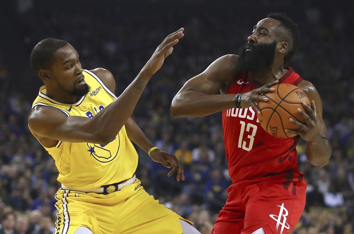 Golden State Warriors’ Kevin Durant, left, defends against Houston Rockets’ James Harden during the first half of an NBA basketball game Thursday, Jan. 3, 2019, in Oakland, Calif. (AP Photo/Ben Margot)