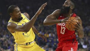 Golden State Warriors’ Kevin Durant, left, defends against Houston Rockets’ James Harden during the first half of an NBA basketball game Thursday, Jan. 3, 2019, in Oakland, Calif. (AP Photo/Ben Margot)