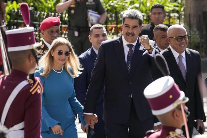 Venezuelan President Nicolas Maduro and his wife Cilia Flores arrive at the National Assembly for his swear-in ceremony for a third term in Caracas, Venezuela, Friday, Jan. 10, 2025. (AP Photo/Matias Delacroix)