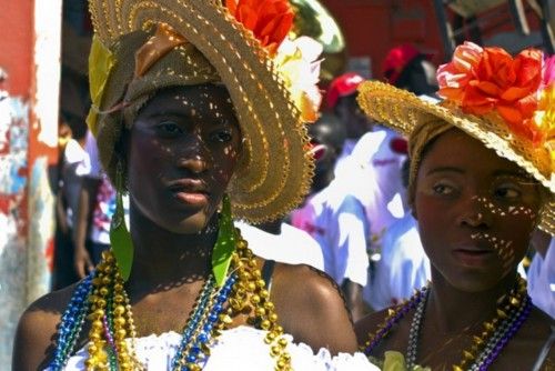 Women wear costumes as they take part in the Jacmel Carnaval
