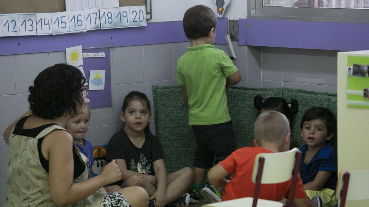 Imagen de archivo de una profesora de infantil con varios alumnos