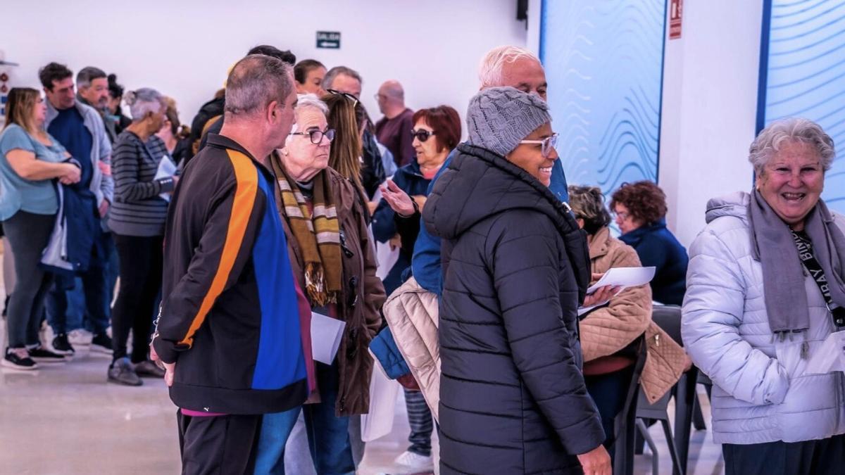 Decenas de persona esperan para poder adquirir uno de los bonos comerciales.