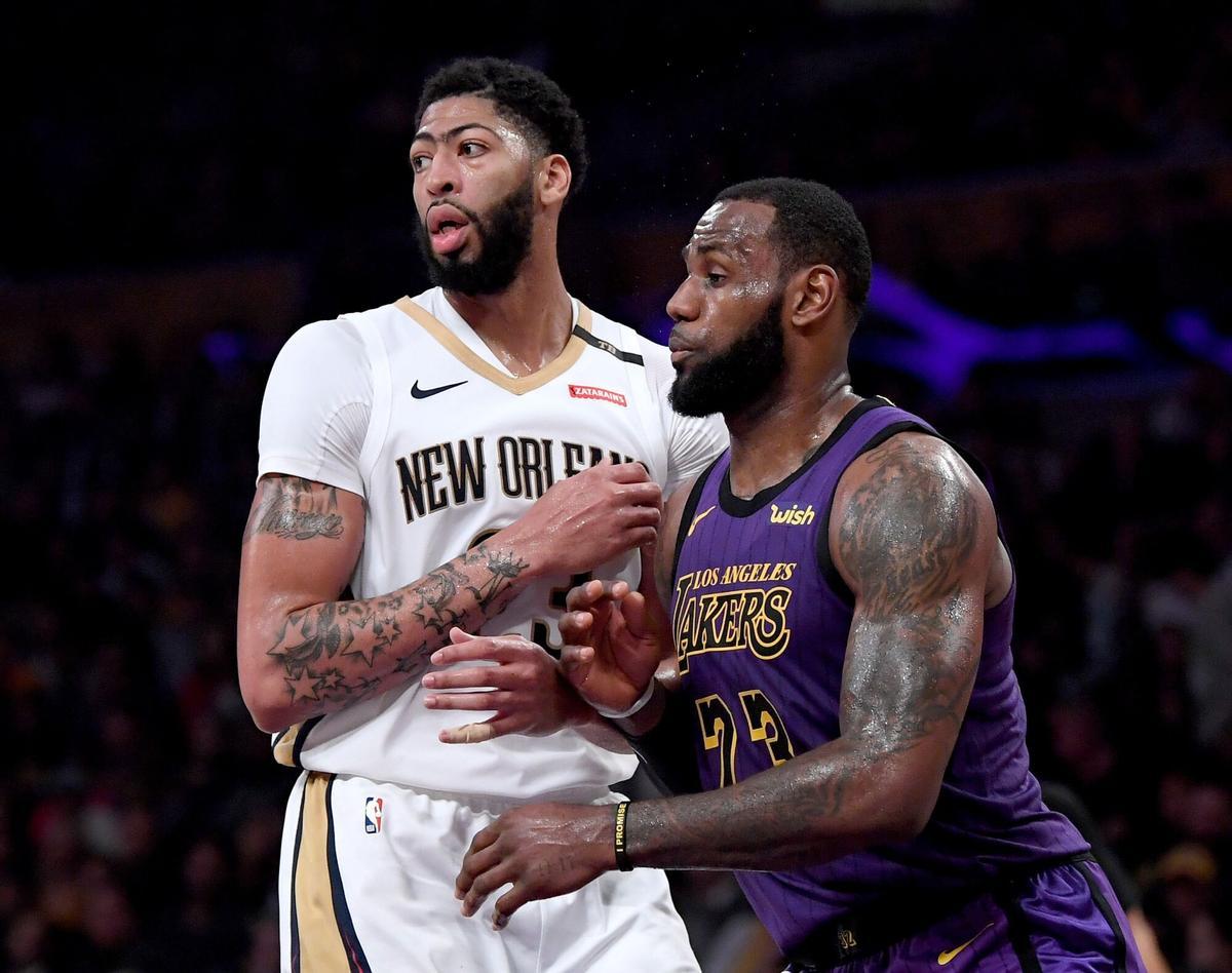 FILE - JUNE 15: The Los Angeles Lakers have traded Lonzo Ball, Brandon Ingram, Josh Hart and three first-round picks to the New Orleans Pelicans for star Anthony Davis on June 15, 2019. LOS ANGELES, CALIFORNIA - DECEMBER 21: LeBron James #23 of the Los Angeles Lakers guards Anthony Davis #23 of the New Orleans Pelicans during a 112-104 Laker win at Staples Center on December 21, 2018 in Los Angeles, California. NOTE TO USER: User expressly acknowledges and agrees that, by downloading and or using this photograph, User is consenting to the terms and conditions of the Getty Images License Agreement. Harry How/Getty Images/AFP== FOR NEWSPAPERS, INTERNET, TELCOS &amp; TELEVISION USE ONLY ==