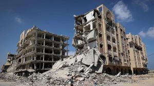 A displaced Palestinian boy walks past destroyed buildings in the east of Deir al-Balah, central Gaza Strip on July 22, 2026, as violence has continued in Gaza despite the ceasefire. Gaza remains gripped by daily violence, with both the Israeli military and Hamas accusing one another of violating the truce in effect since October 10. The war flattened swathes of the territory, displaced most of the population at least once, and left hundreds of thousands of people living in tents and temporary shelters. (Photo by Eyad Baba / AFP)